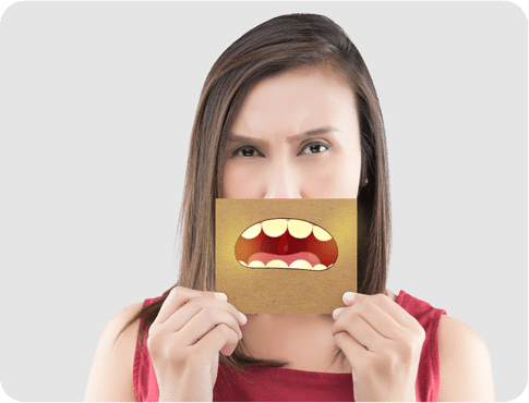 Woman holding the card with bad breath illustration in front of her mouth