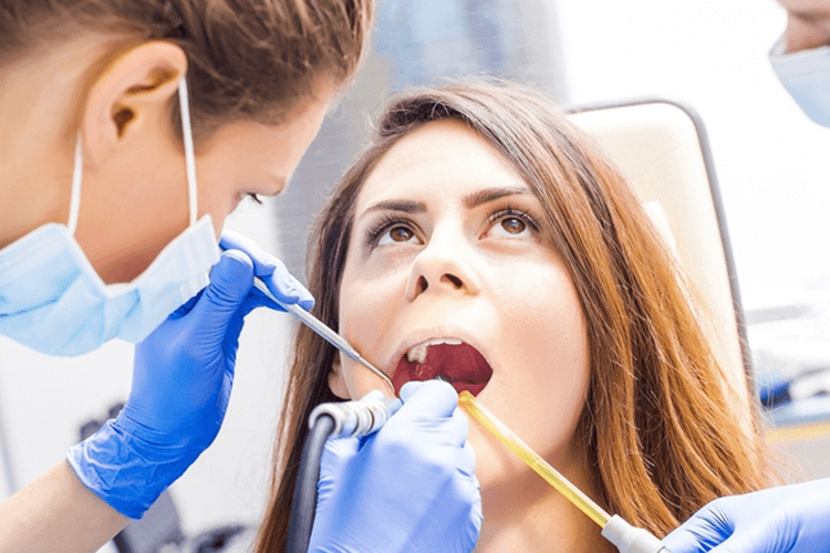 Close up of the woman mouth getting Dental checkup